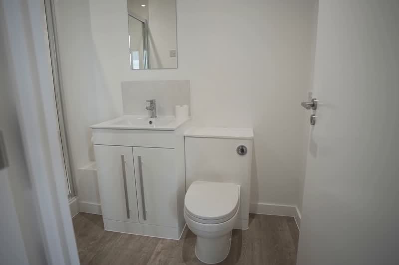 Slow pan across a private en-suite bathroom with shower at Cuthbert House